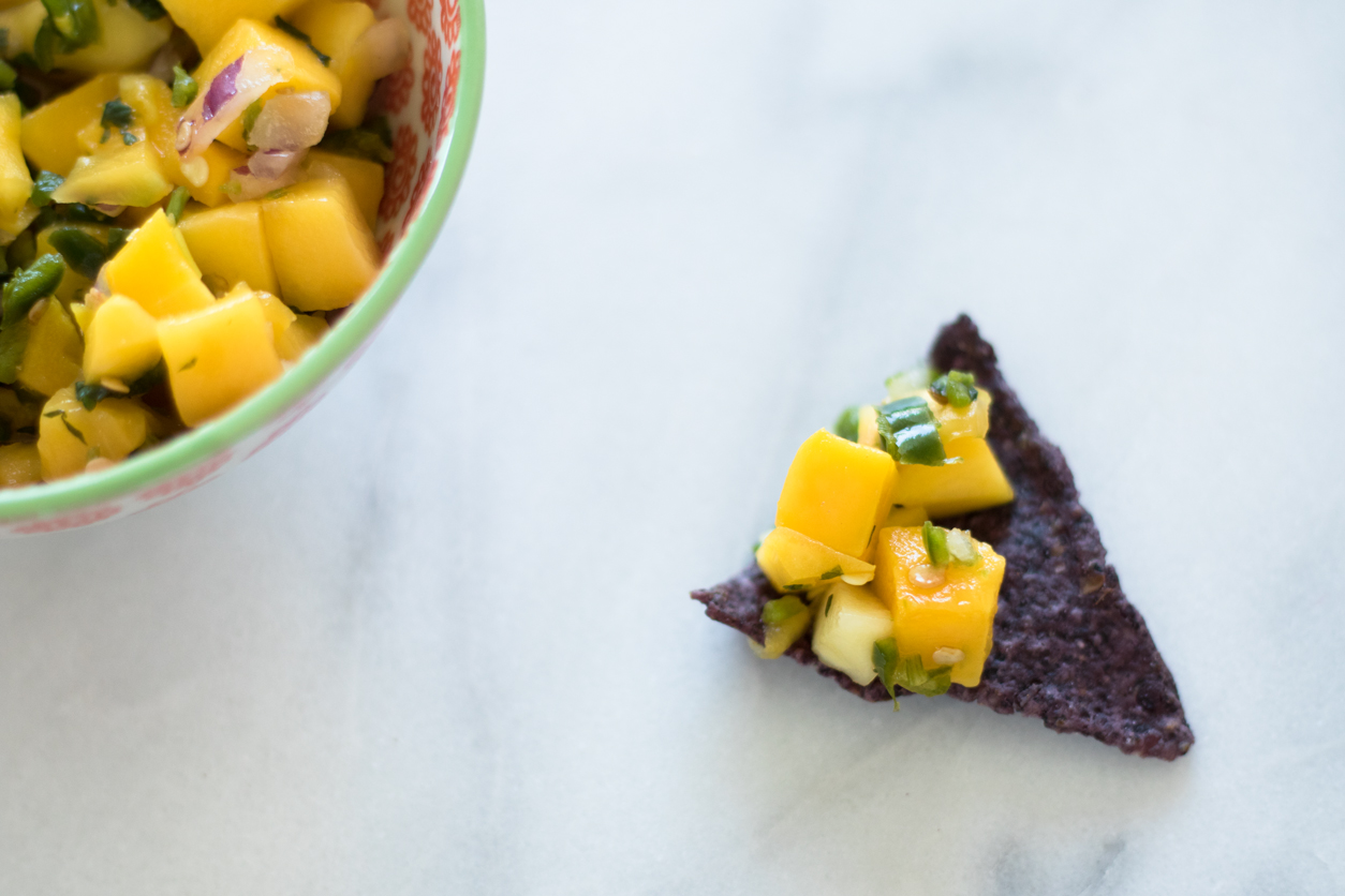 Favorite store bought guacamole for National Tortilla Chip Day_joyfetti.com_Whole Foods mango salsa on chip