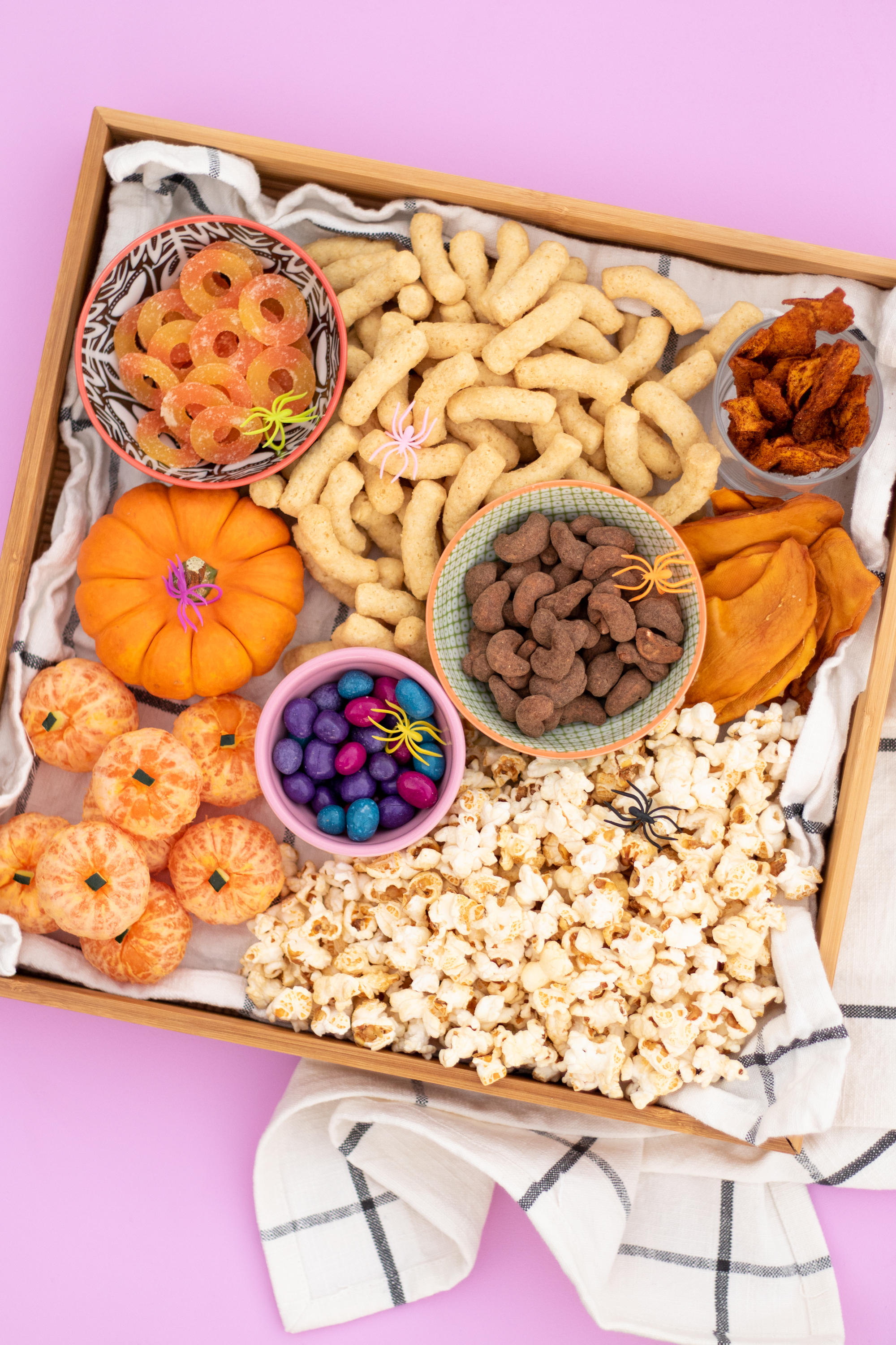 https://joyfetti.com/wp-content/uploads/2020/10/halloween-movie-night-snack-tray-board-vegan-smartsweets-unreal-candies-whole-foods-wrapped-cashews-solely-natierra-angies-boomchickapop-hippeas-fruit-pumpkin-cuties-center-joyfetti.jpg